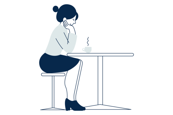 Woman Sitting at Table with Hot Cup